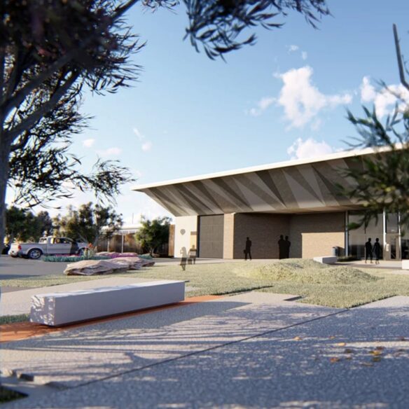 Modern building with wide roof and landscaped entry path.