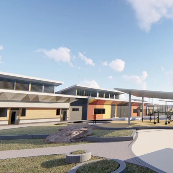 Courtyard view with modern buildings, canopy, and landscaped garden beds.