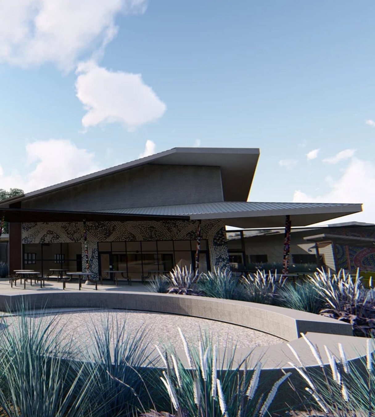 Pavilion-style building with a large overhanging roof and landscaped courtyard.
